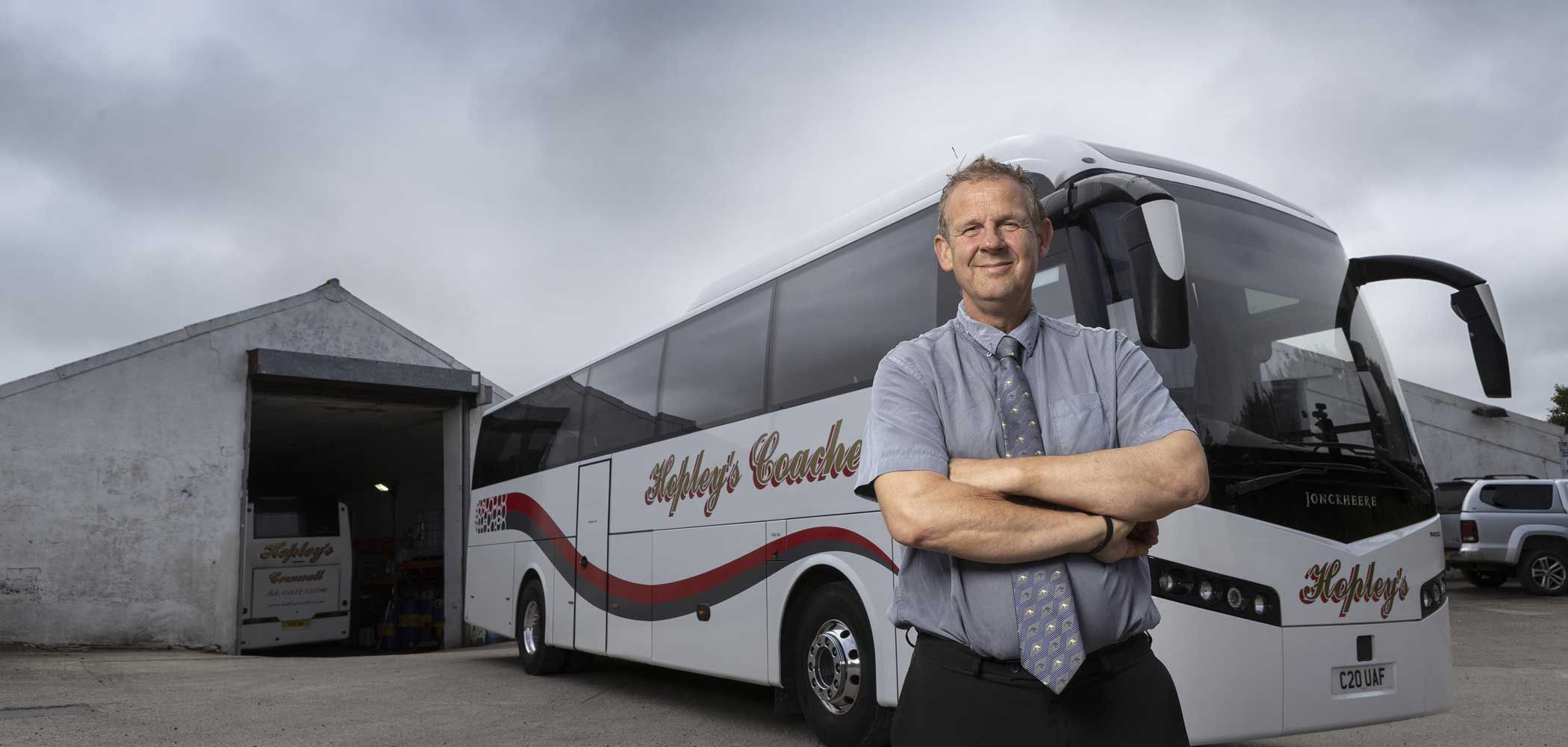 Nicholas Hopley standing in front of a Hopley's coach