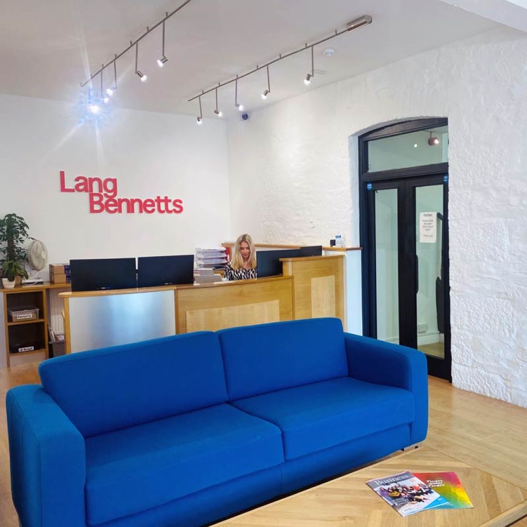 Lang Bennetts reception area, with blue sofa and reception desk
